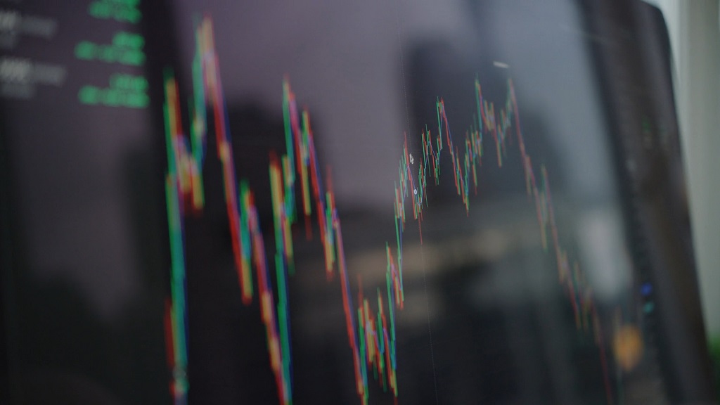 Prikaz dinamičkog grafikona sa svećama na ekranu, simbolizujući pametno i odgovorno investiranje u ETF fondove