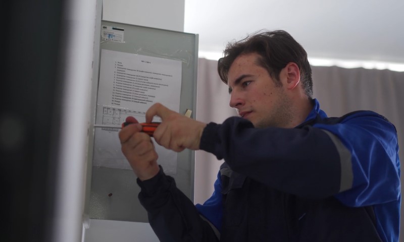 Električar popravlja razvodnu kutiju
