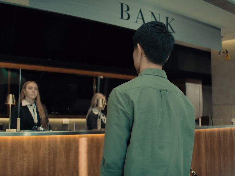 Osoba čeka red na šalteru u banci