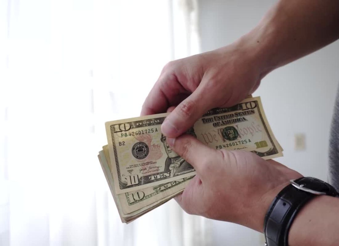 momak drži novac u rukama